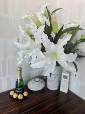 a vase filled with white flowers on a table at Apartment Lupáčova in Prague