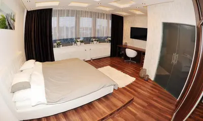 a bedroom with a white bed and a window at Apartment Lupáčova in Prague