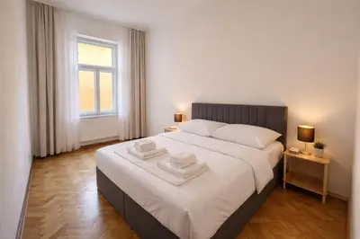 a bedroom with a large bed with two towels on it at Lidická 31 Apartment Prague ,2 Bedrooms ,8 Guests ,Near Center in Prague