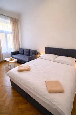 a bedroom with a large bed and a couch at Lidická 31 Apartment Prague ,2 Bedrooms ,8 Guests ,Near Center in Prague