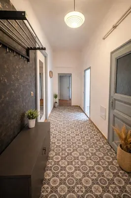an empty hallway with a tile floor and a door at Lidická 31 Apartment Prague ,2 Bedrooms ,8 Guests ,Near Center in Prague