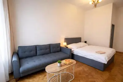 a living room with a bed and a couch at Lidická 31 Apartment Prague ,2 Bedrooms ,8 Guests ,Near Center in Prague