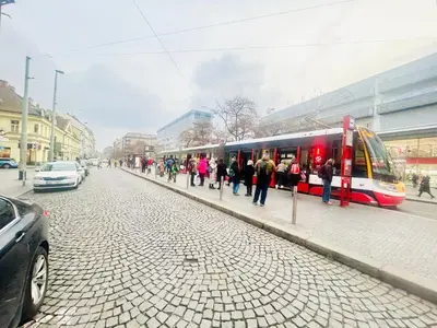 a group of people standing next to a train at Lidická 31 Apartment Prague ,2 Bedrooms ,8 Guests ,Near Center in Prague
