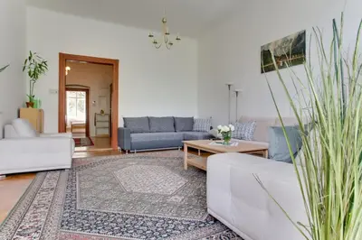 a living room with couches and a table at Charming 2BR Garden Views in Historic Vinohrady in Prague