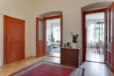 a hallway with a door open to a living room at Charming 2BR Garden Views in Historic Vinohrady in Prague
