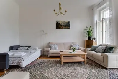a living room with a couch and a table at Charming 2BR Garden Views in Historic Vinohrady in Prague
