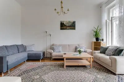 a living room with two couches and a coffee table at Charming 2BR Garden Views in Historic Vinohrady in Prague