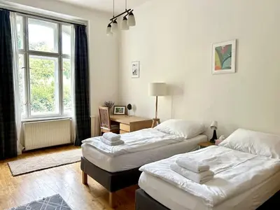 a bedroom with two beds and a window at Spacious 2BR in Historical Vinohrady in Prague