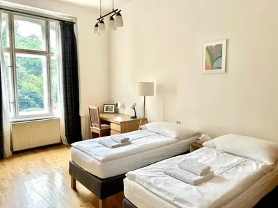 a bedroom with two beds and a window at Spacious 2BR in Historical Vinohrady in Prague