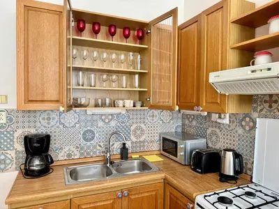 a kitchen with a sink and a microwave at Spacious 2BR in Historical Vinohrady in Prague