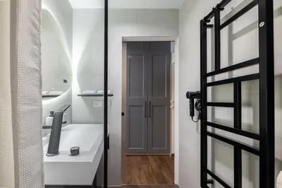 a bathroom with a glass door and a sink at Prague Castle View by Charles Bridge in Prague