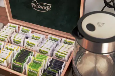 a box of green and white packets of food next to a blender at Old Prague View Rooftop Studio with AC in Prague
