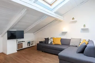 a living room with a couch and a flat screen tv at Old Prague View Rooftop Studio with AC in Prague