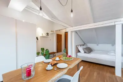 a dining room with a table and a bed at Old Prague View Rooftop Studio with AC in Prague