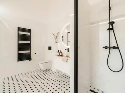 a white bathroom with a shower and a toilet at TurnKey I Grand 5-Bedroom Apartment with Balcony near Wenceslas Square in Prague