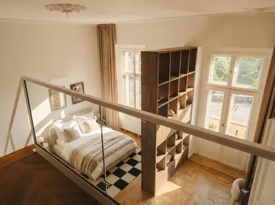 a bedroom with a staircase with a bed in it at TurnKey I Grand 5-Bedroom Apartment with Balcony near Wenceslas Square in Prague
