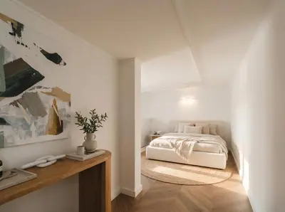 a white bedroom with a bed and a table at TurnKey I Grand 5-Bedroom Apartment with Balcony near Wenceslas Square in Prague