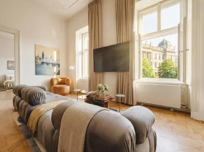 a bedroom with two beds and a large window at TurnKey I Grand 5-Bedroom Apartment with Balcony near Wenceslas Square in Prague