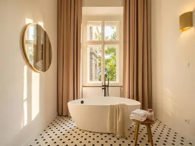 a bath tub in a bathroom with a window at TurnKey I Grand 5-Bedroom Apartment with Balcony near Wenceslas Square in Prague