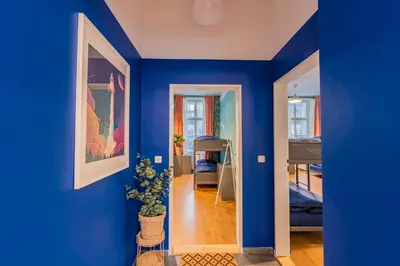 a blue room with a hallway with a blue wall at Luna Female Hostel in Prague