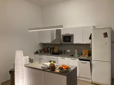 a kitchen with white appliances and a bowl of fruit on a counter at Wenceslas Square Center in Prague