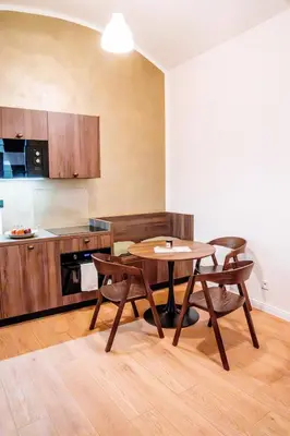 a kitchen with a table and chairs in a room at Amber Nest in the Heart of Prague in Prague