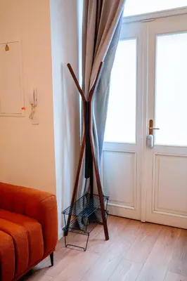 a living room with a couch and a curtain at Amber Nest in the Heart of Prague in Prague