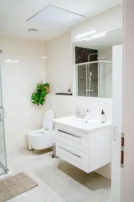 a white bathroom with a sink and a toilet at Amber Nest in the Heart of Prague in Prague