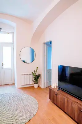 a living room with a large flat screen tv at Amber Nest in the Heart of Prague in Prague
