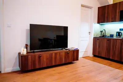 a living room with a large flat screen tv on a wall at Amber Nest in the Heart of Prague in Prague