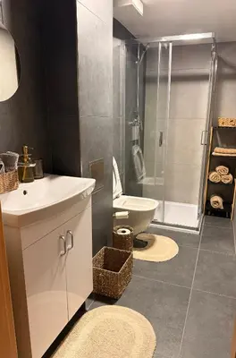 a bathroom with a sink and a toilet and a shower at Garden Studio in Prague