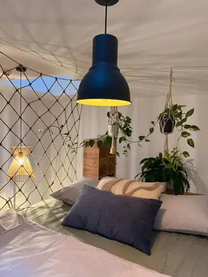 a blue pendant light hanging over a bed at Garden Studio in Prague
