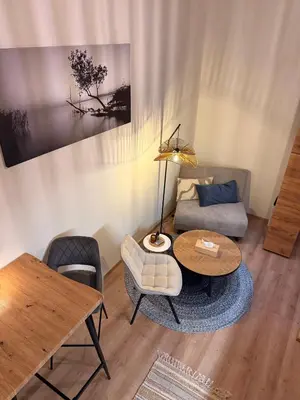 a living room with a couch and a table at Garden Studio in Prague