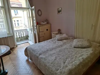 a bedroom with a bed and a large window at Cosy place in Prague 2 Vinohrady in Prague