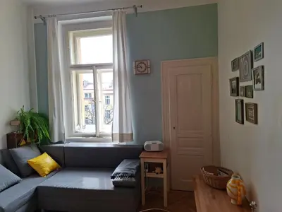 a living room with a couch and a window at Cosy place in Prague 2 Vinohrady in Prague