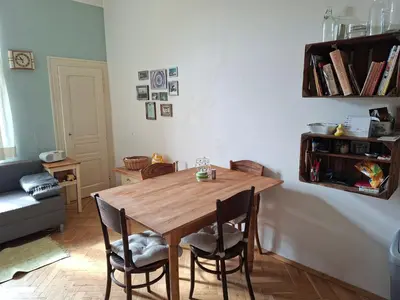a wooden table and chairs in a living room at Cosy place in Prague 2 Vinohrady in Prague