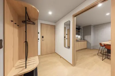 a room with a hallway with a door and a table at Malleta Living in Prague