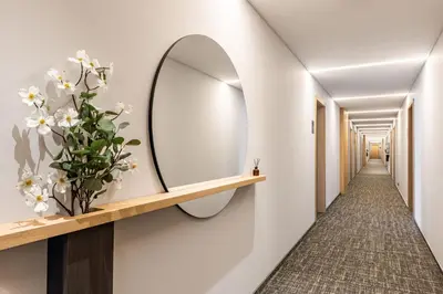 a hallway with a mirror on the wall at Malleta Living in Prague