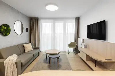 a living room with a couch and a tv at Malleta Living in Prague