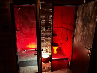 a red bathroom with a toilet in a room at Playroom Prague Vinohrady in Prague