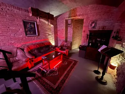 a living room with a couch and a brick wall at Playroom Prague Vinohrady in Prague