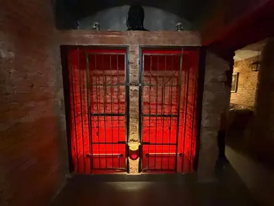 a red door in a room with a brick wall at Playroom Prague Vinohrady in Prague