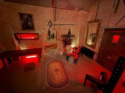 a living room with a brick wall and a table and chairs at Playroom Prague Vinohrady in Prague
