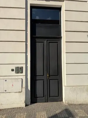 a black door on the side of a building at Playroom Prague Karlín in Prague