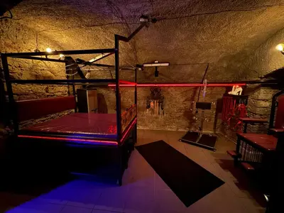 a dark room with a bed and a red light at Playroom Prague Karlín in Prague