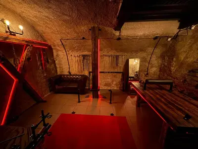 a room with a couch and a bench in a cave at Playroom Prague Karlín in Prague