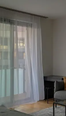 a living room with a window and a piano at Viktorka in Prague