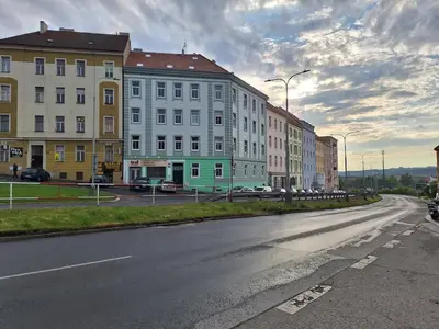 an empty street in a city with buildings at Cozy and newly equipped apartment in Prague