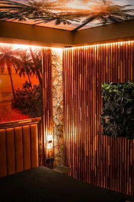 a room with a table and a wall of wood at Coco Suite Private Spa and Jacuzzi Prague Center in Prague