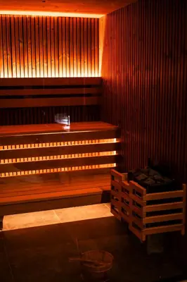 a sauna with a wooden bench in a room at Coco Suite Private Spa and Jacuzzi Prague Center in Prague